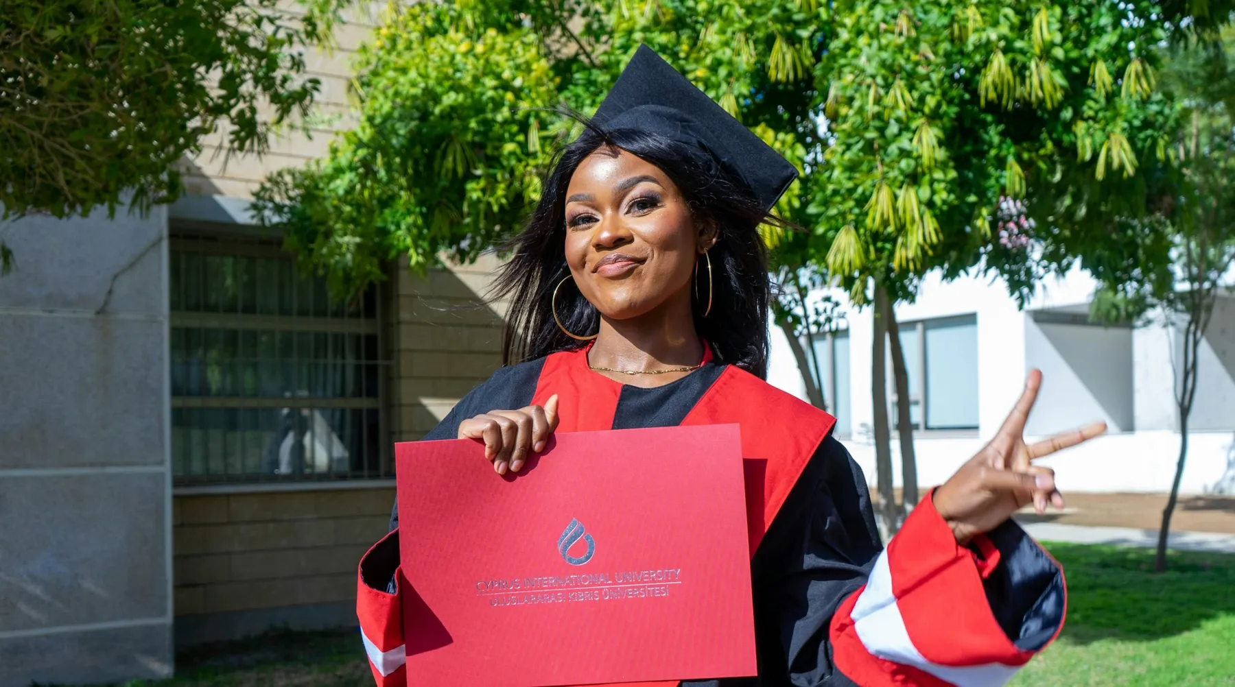 A graduate holding her certificate
