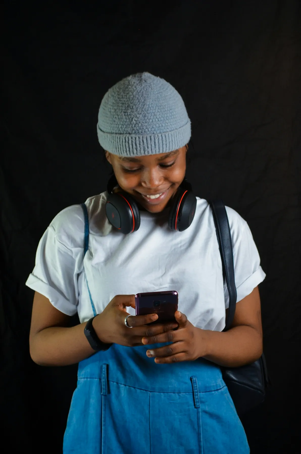 A student smiling at her phone